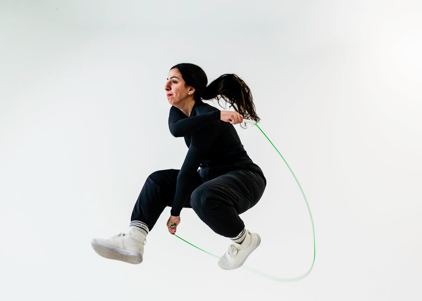 Person jumping rope on a plain background