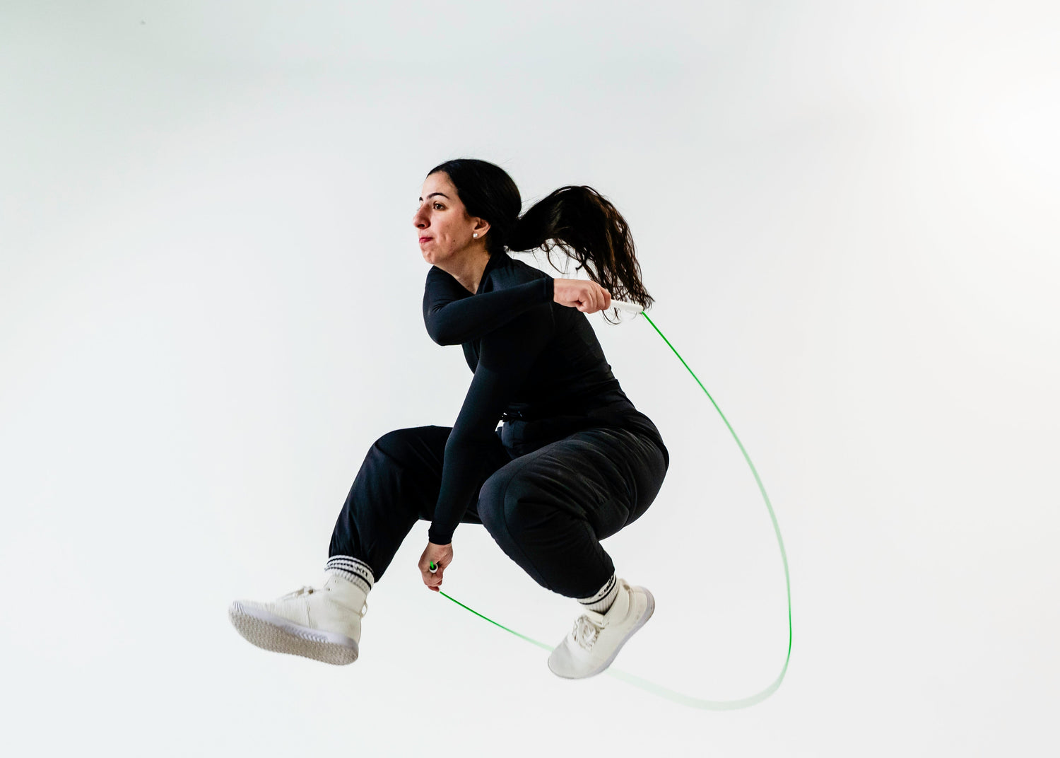 Person jumping rope on a plain background